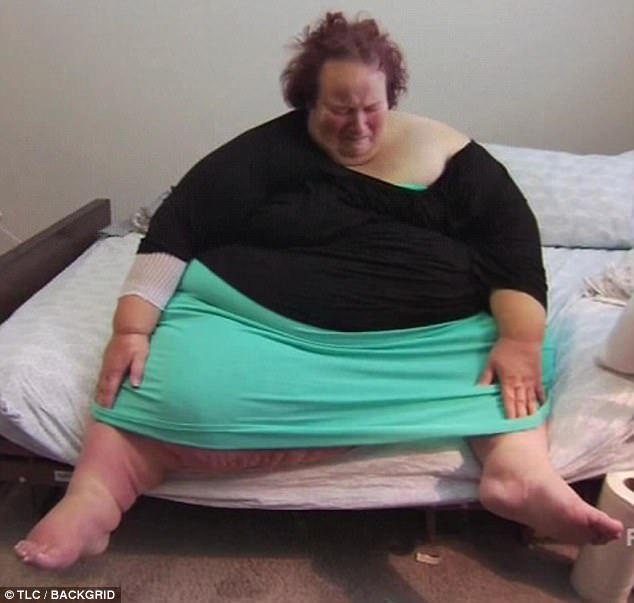 Janine Mueller sitting on a bed in an archival photograph