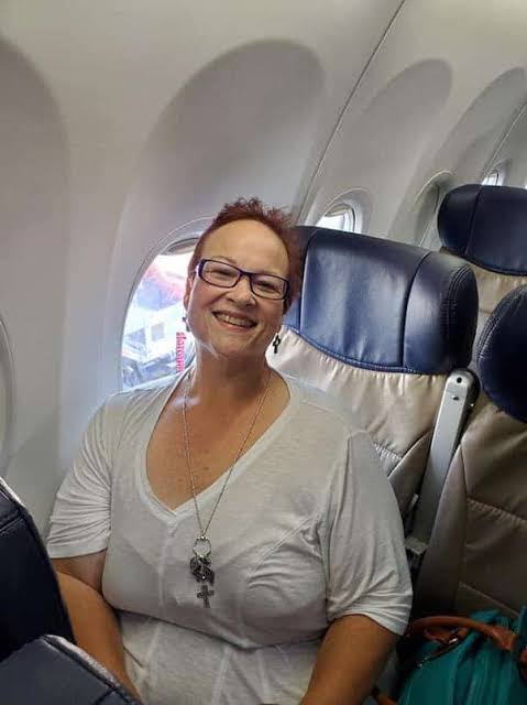 Janine Mueller smiling while seated on an airplane